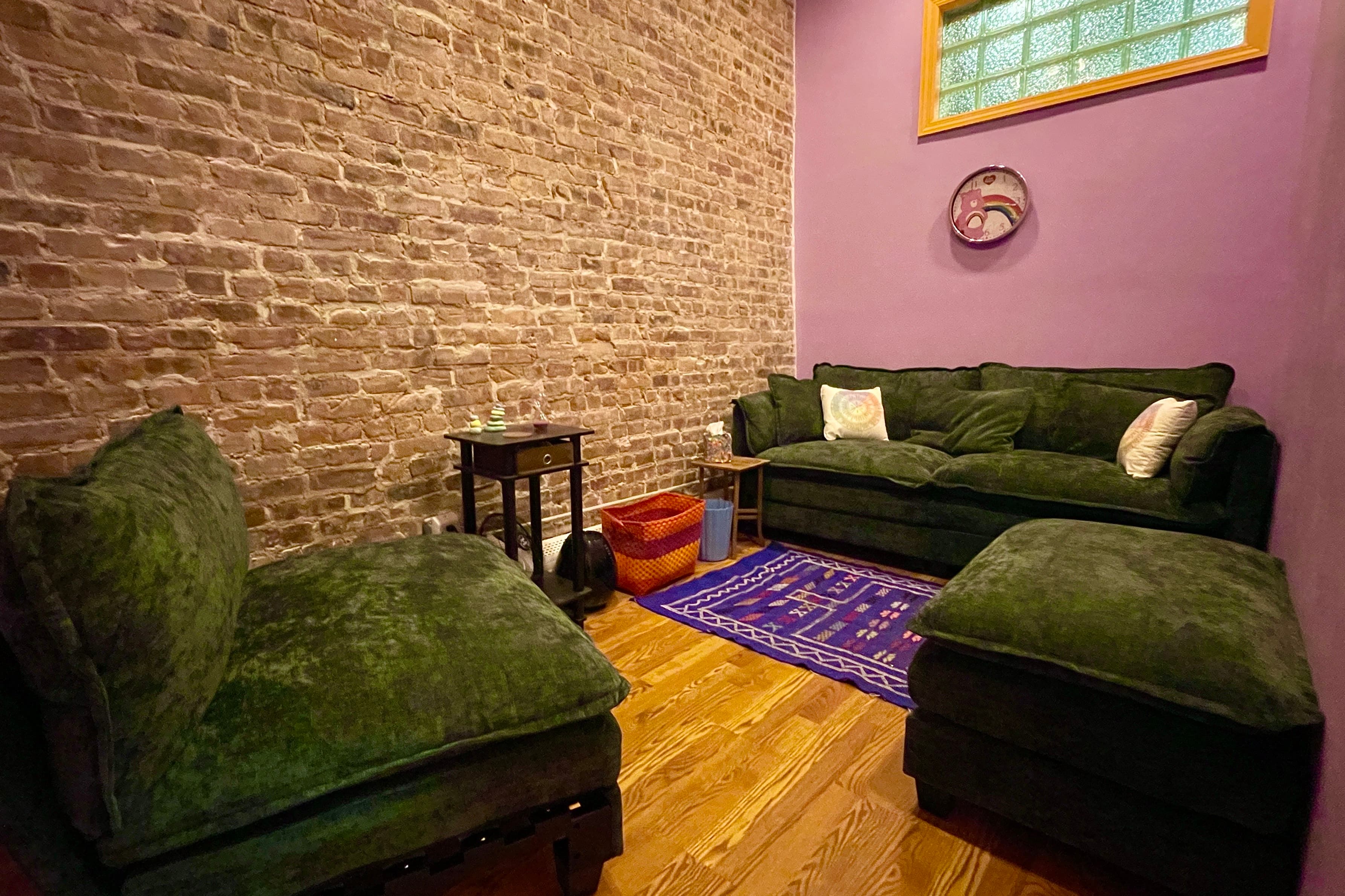 Purple room with seating and soft lighting